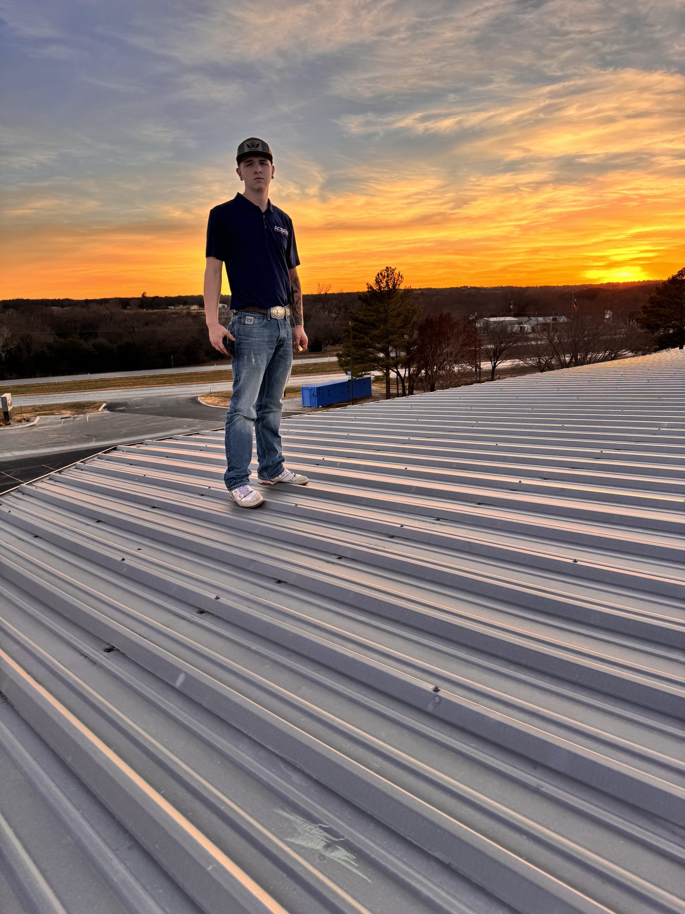 Acorn Roofing crew finishing a commercial roof at dusk
