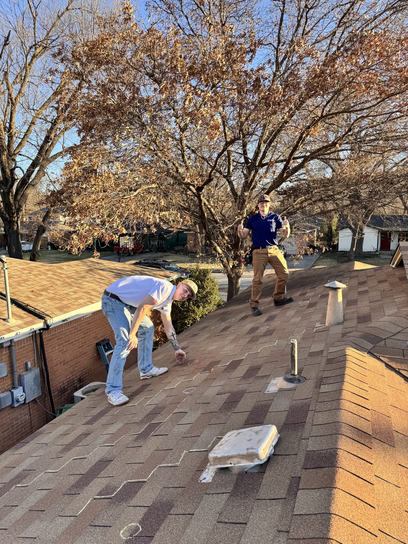 Roofing crew replacing shingles on a North Dallas home